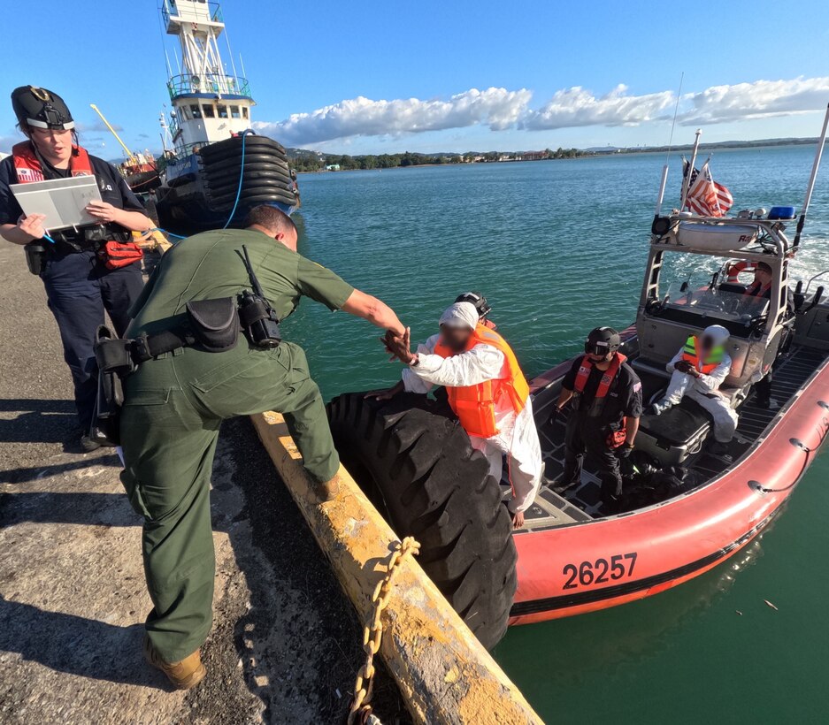 U.S. Border Patrol and Homeland Security Investigations agents in Mayaguez, Puerto Rico, receive custody of four migrants from a Coast Guad boat crew, following the interdiction of an unlawful irregular migration voyage off, Puerto Rico, Jan. 13, 2025. The migrants face possible federal prosecution by the U.S. Attorney’s Office for the District of Puerto Rico on charges of attempt to illegally reenter the United States in violation of Title 8 U.S.C. Section 1326, and failure to heave in violation of Title 18 U.S.C. Section 2237. (U.S. Coast Guard photo)