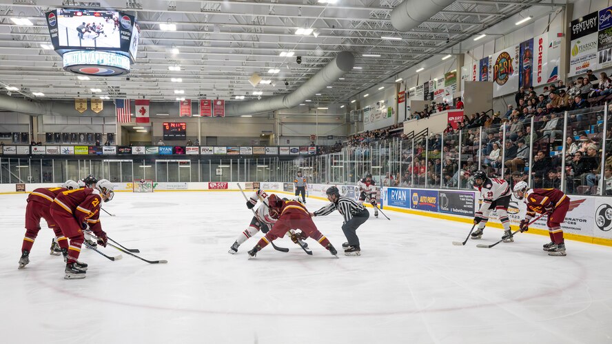 Minot State University Beavers and Iowa State University Cyclones players prepare for a face-off during the MSU military appreciation hockey game at Maysa Arena, Minot, North Dakota, Jan. 11, 2025. A face-off is the method of restarting play during a hockey game after a penalty occurs or a goal is scored. (U.S. Air Force photo by Senior Airman Kyle Wilson)