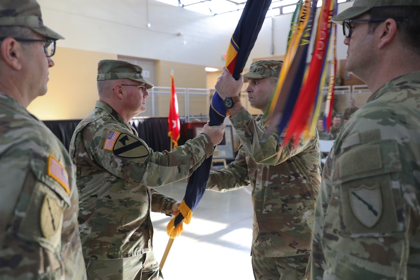 Col. Steven Engels receives the brigade's guidon from Brig. Gen. Joseph Lear, assuming command from Col. Jason Penn during the Change of Command ceremony held at the Wellman Armory on Boone National Guard Center in Frankfort, Ky. Jan 12, 2025.