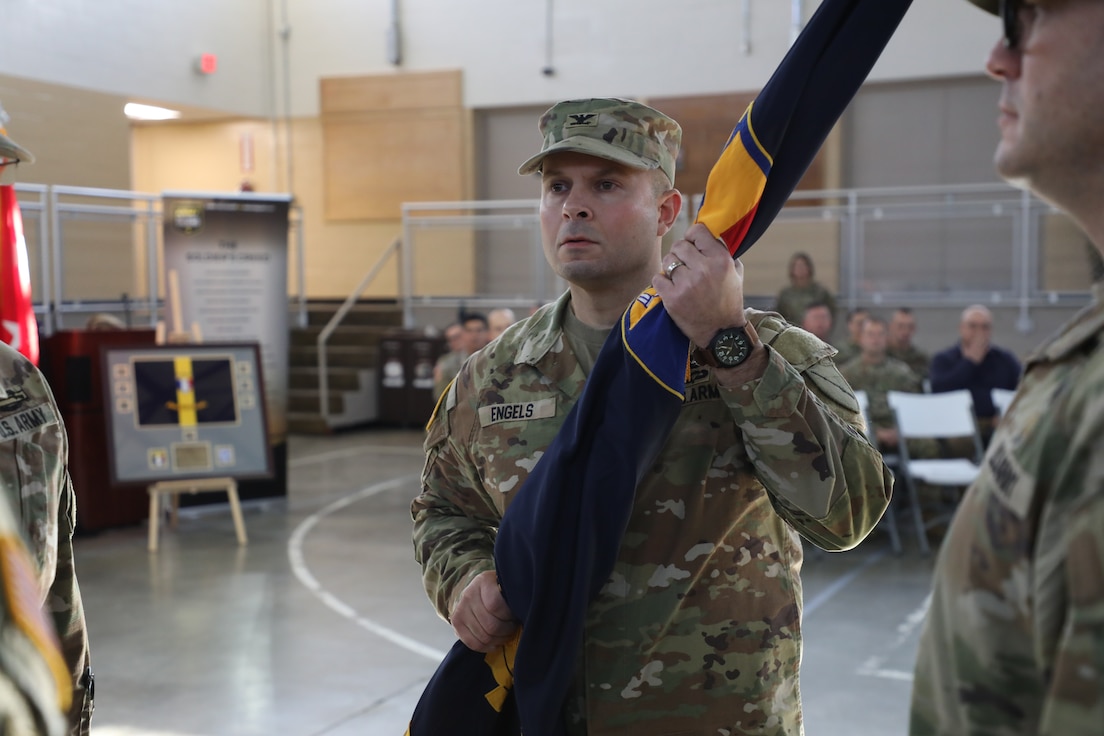 Col. Steven Engels hold the brigade's guidon after assuming command from Col. Jason Penn during a Change of Command ceremony held at the Wellman Armory on Boone National Guard Center in Frankfort, Ky. Jan 12, 2025.