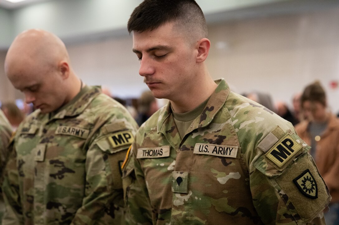 U.S. Army Sgt. Jacob Thomas bows his head in prayer at the 617th Military Police Company deployment ceremony at the Armed Forces Reserve Center in Richmond, Kentucky on Jan. 4, 2025.