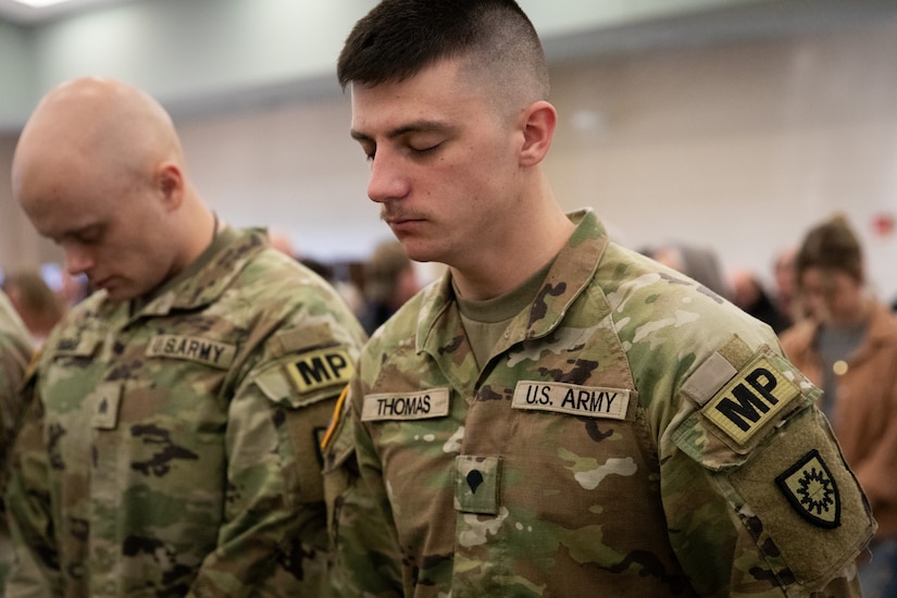 U.S. Army Sgt. Jacob Thomas bows his head in prayer at the 617th Military Police Company deployment ceremony at the Armed Forces Reserve Center in Richmond, Kentucky on Jan. 4, 2025.