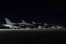 Aircraft are parked together on a flightline.