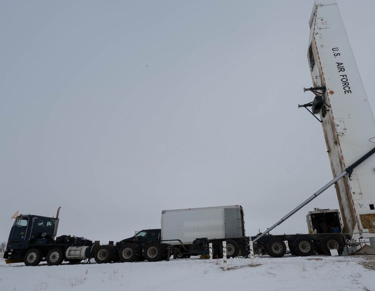 Airmen assigned to the 91st Missile Maintenance Squadron perform maintenance on a Minuteman III missile using a transporter erector at Minot Air Force Base, North Dakota, Jan. 14, 2025. The transporter erector units will be replaced with newer, more efficient models that will help usher in the new age of missile reliability and nuclear deterrence. (U.S. Air Force photo by Airman 1st Class Wesley Davies)