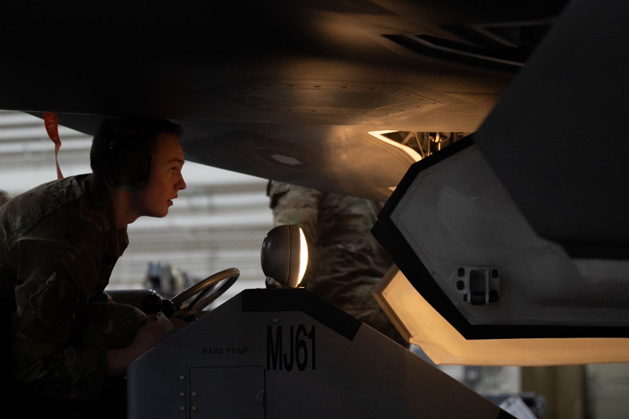 U.S. Air Force Airman loads an AIM-120 Advanced Medium Range Air-to-Air Missile into a F-35A Lightning II during the fourth quarter load competition