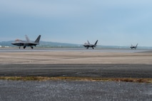 U.S. Air Force F-22A Raptors assigned to the 525th Expeditionary Fighter Squadron, taxi down the runway during a base-wide, readiness exercise at Kadena Air Base, Japan, Jan. 15, 2025.