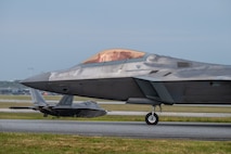 .S. Air Force F-22A Raptors assigned to the 525th Expeditionary Fighter Squadron taxi down the runway during a base-wide readiness exercise at Kadena Air Base, Japan, Jan. 15, 2025.