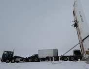 Airmen assigned to the 91st Missile Maintenance Squadron perform maintenance on a Minuteman III missile using a transporter erector at Minot Air Force Base, North Dakota, Jan. 14, 2025. The transporter erector units will be replaced with newer, more efficient models that will help usher in the new age of missile reliability and nuclear deterrence. (U.S. Air Force photo by Airman 1st Class Wesley Davies)
