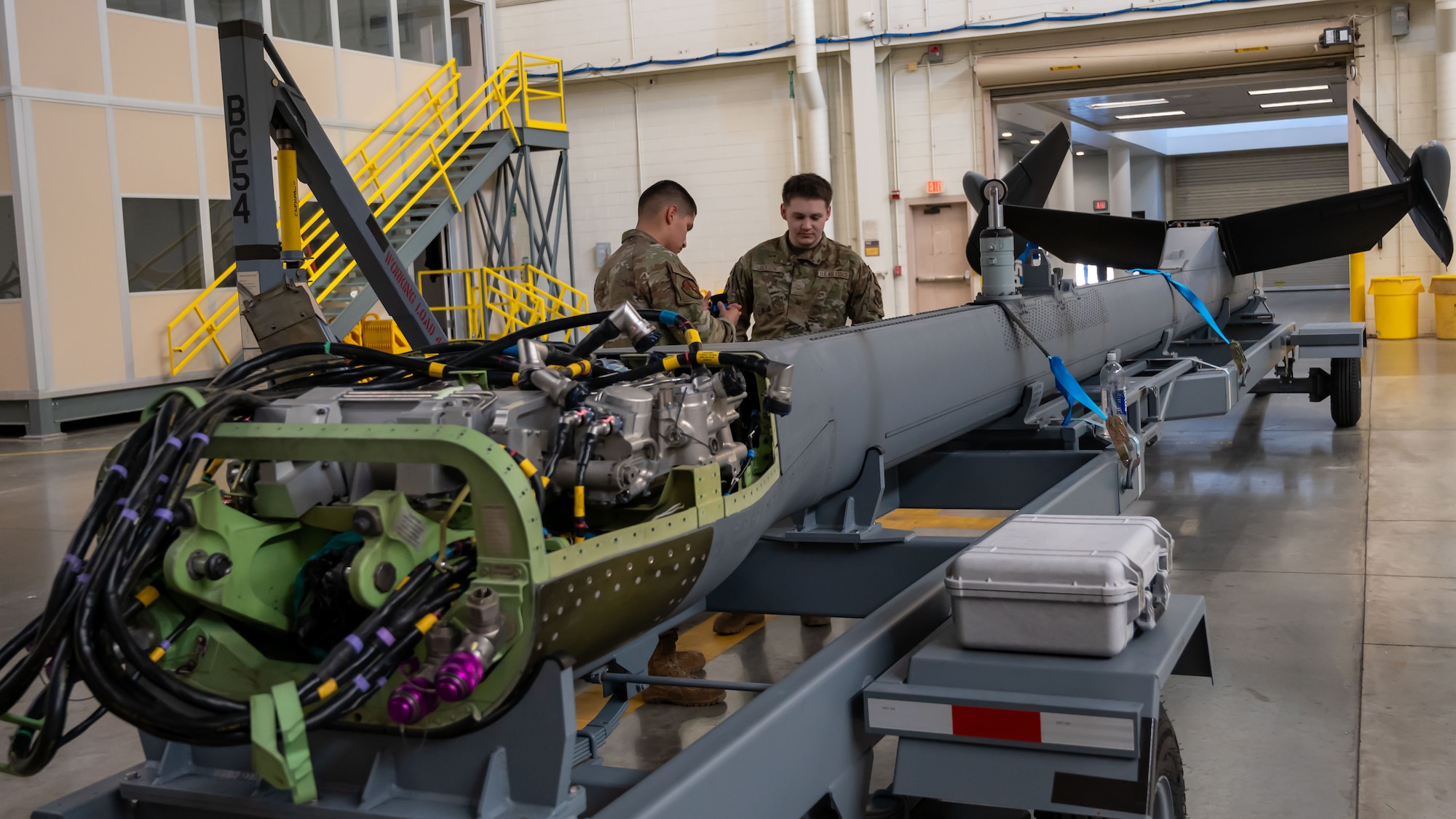U.S. Air Force Airman 1st Class Franz Christerer and Airman 1st Class Braydee Jackson, 605th Aircraft Maintenance Squadron hydraulics specialist journeymen, review repair procedures pertaining to the KC-46A Pegasus aerial refueling aircraft boom gimbal at Joint Base McGuire-Dix-Lakehurst, N.J., Jan. 14, 2025. The 605th AMXS is responsible for flightline maintenance, inspection and repair efforts that keep the KC-46A flying and ready to perform its mission. (U.S. Air Force photo by Susan Moriarty)