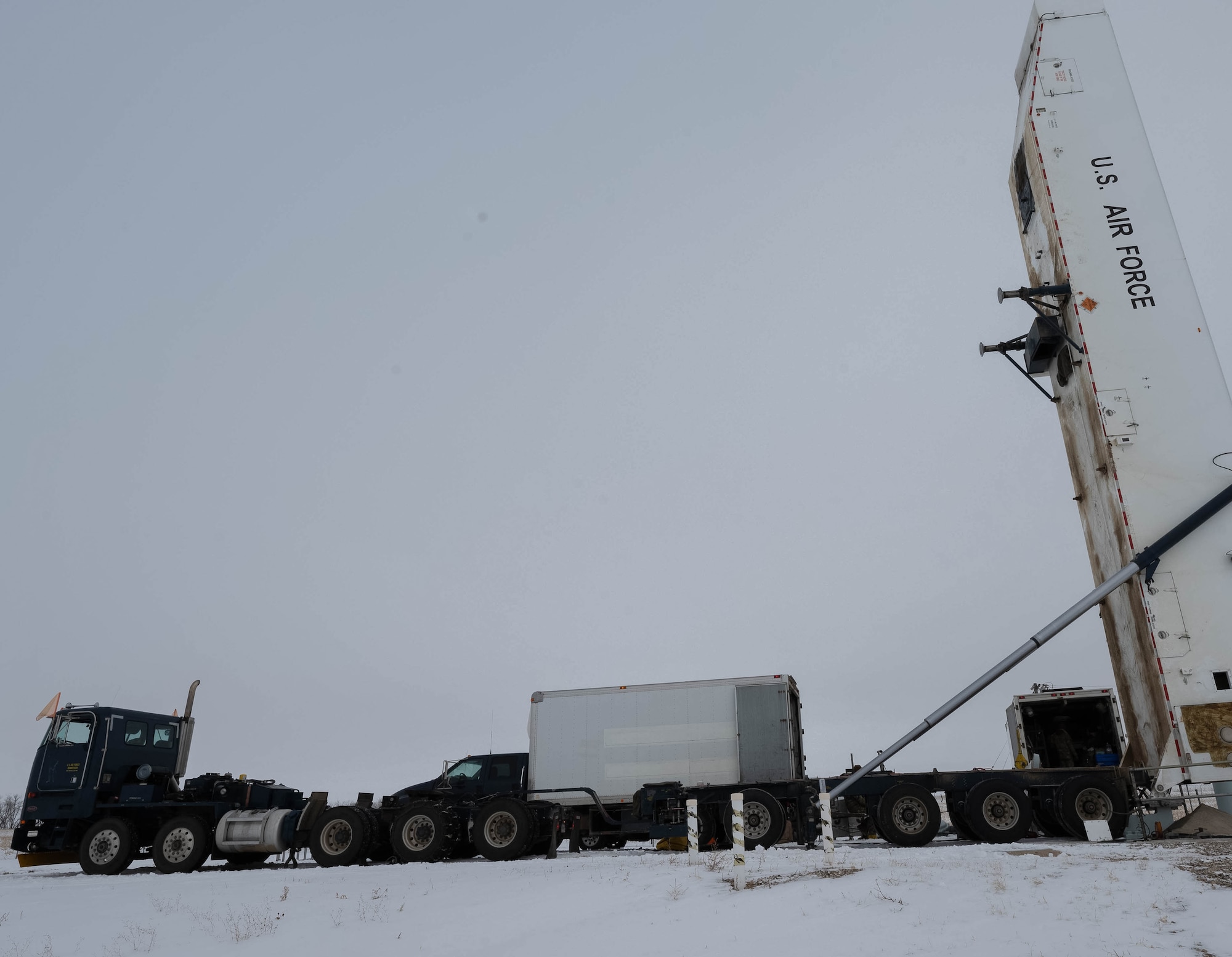 Airmen assigned to the 91st Missile Maintenance Squadron perform maintenance on a Minuteman III missile using a transporter erector at Minot Air Force Base, North Dakota, Jan. 14, 2025. The transporter erector units will be replaced with newer, more efficient models that will help usher in the new age of missile reliability and nuclear deterrence. (U.S. Air Force photo by Airman 1st Class Wesley Davies)