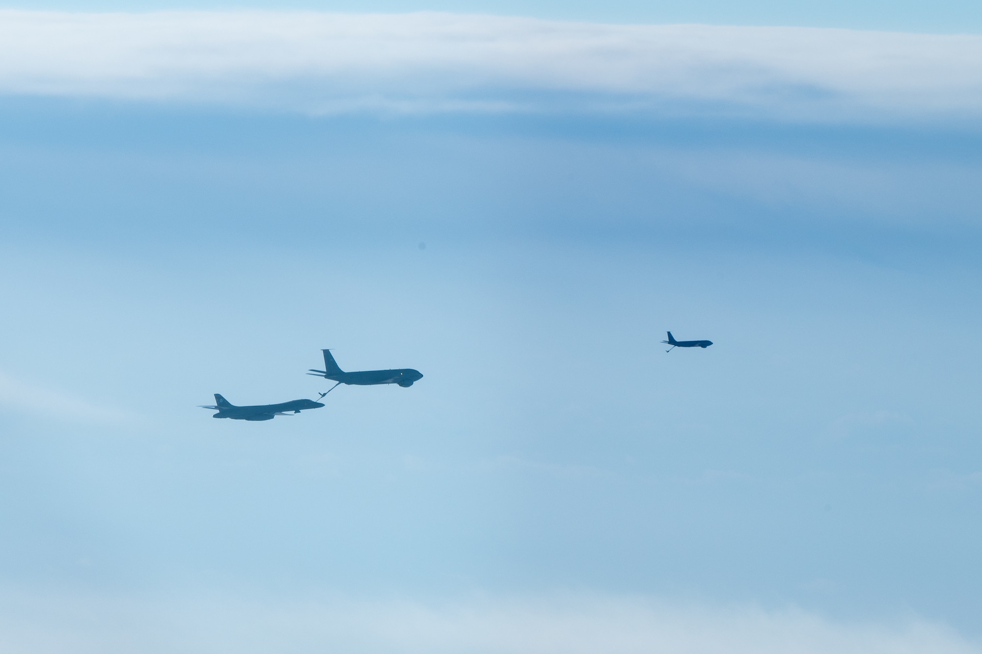 A bomber conducts aerial refueling with a tanker aircraft.