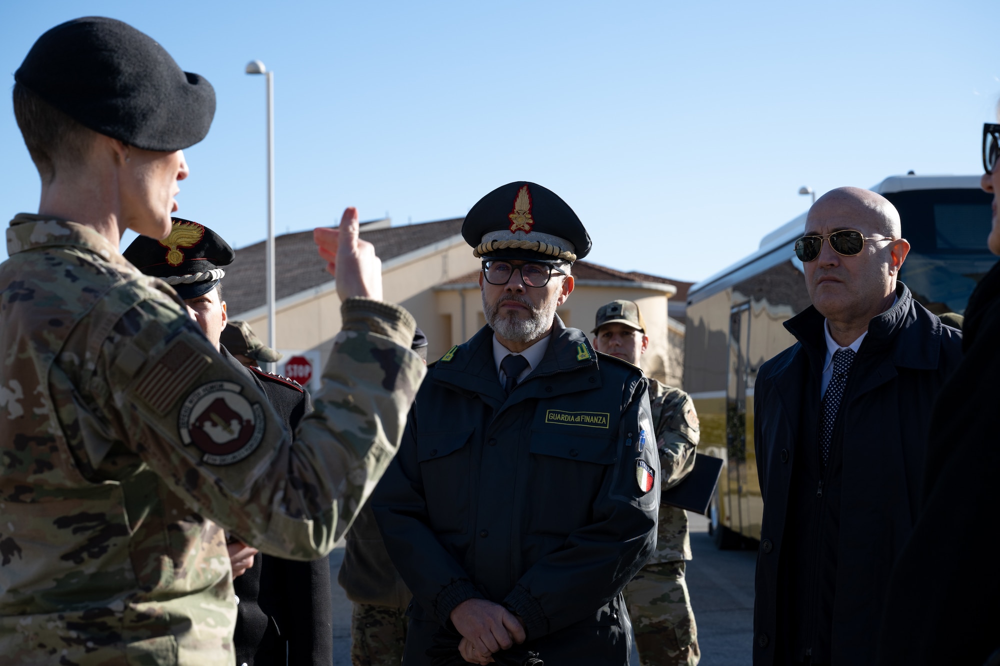U.S. Air Force Lt. Col. Kimberly Guest, 31st Security Forces Squadron commander (left), briefs Italian Col. Davide Cardia, the comandante provinciale Guardia di Finanza (center), and Prefect of Pordenone, Michele Lastella (right), on recent partnerships with local Italian police at Aviano Air Base, Italy, Jan. 14, 2025.