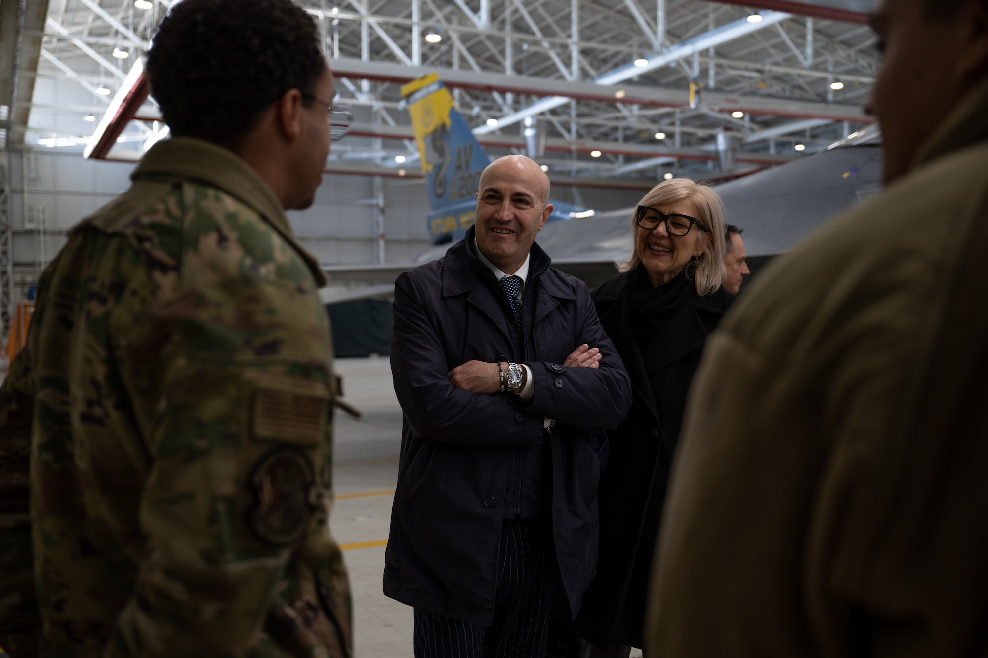 Prefect of Pordenone, Michele Lastella (center), converses with maintainers from the 31st Fighter Wing at Aviano Air Base, Italy, Jan. 14, 2025.