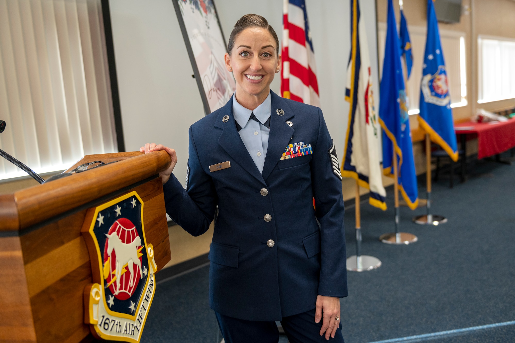 a woman in uniform stands at a podium