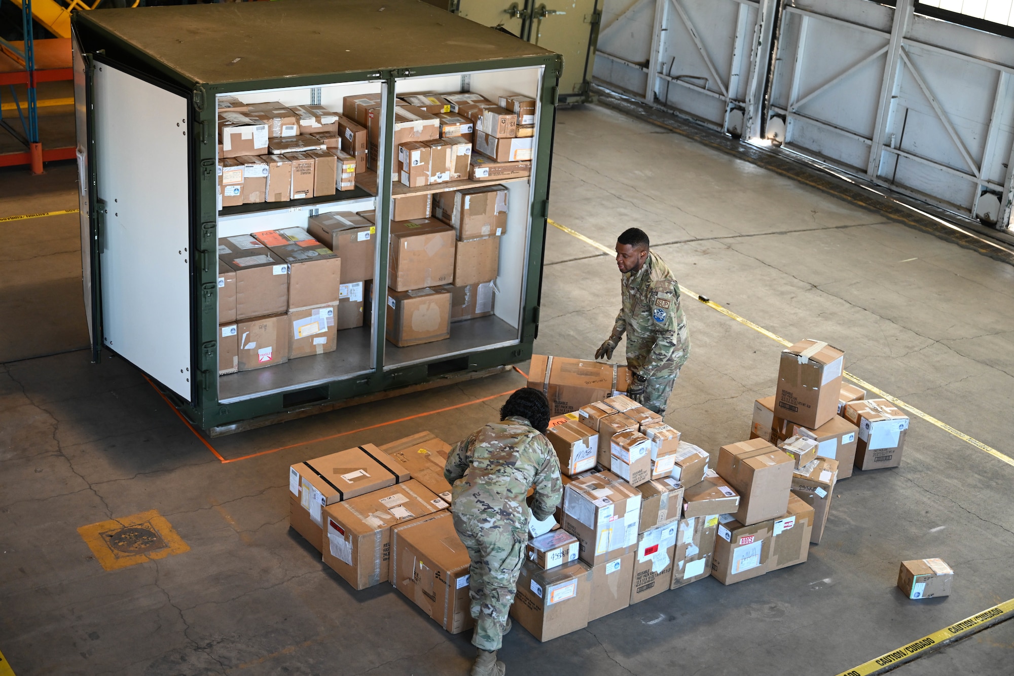 Participants load an ISU-90 military container with cargo boxes during the space logistics challenge at Peterson Space Force Base, Colorado, Jan. 15, 2025. The first step of the space logistic challenge was to have members of different skill levels load 111 boxes of cargo into a standard military container to set the base line for the artificial intelligence’s turn later in the day. (U.S. Space Force photo by Staff Sgt. Jaime Sanchez)