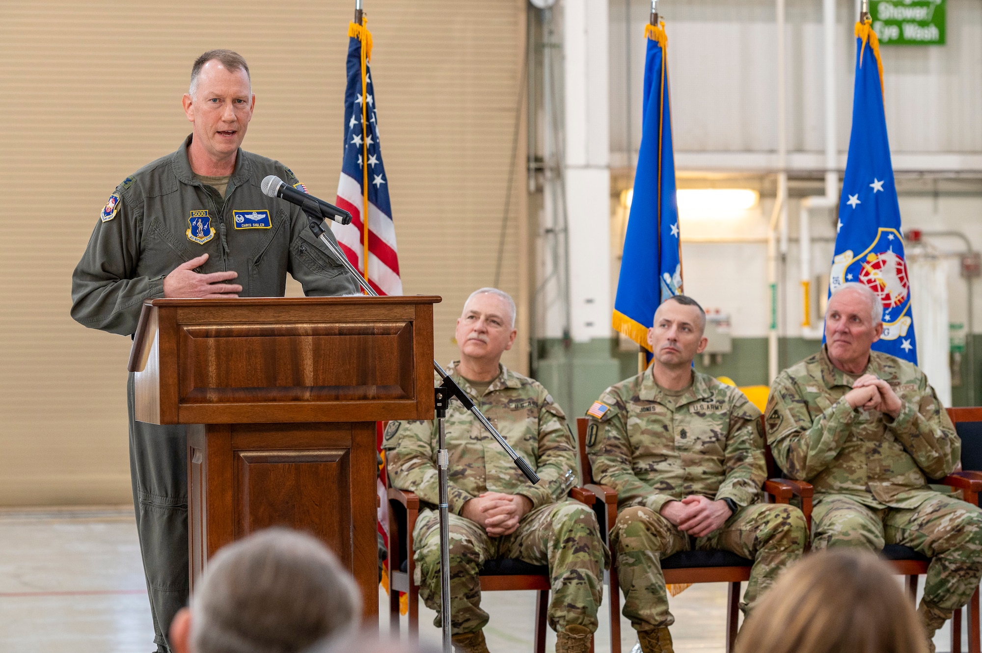 a man stands at a podium on a stage