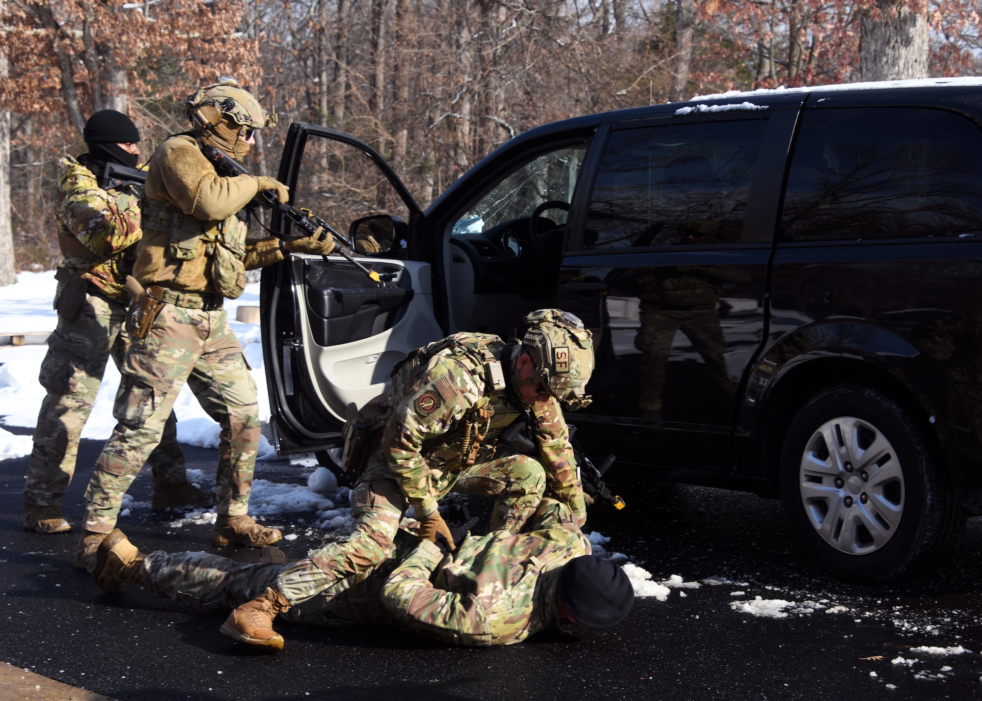Defenders from the 459th Security Forces Squadron conduct "Critical Skills Training” (CST) series, Jan. 11, 2025, at Joint Base Andrews, Md. This iteration provided repetitions in vehicle interdiction/high risk traffic stops, patrolling with degraded tactical communications, and an overview of Grey Zone Warfare. CST prepares Defenders to operate at contingency locations in a near-peer fight scenario. (U.S. Air Force photo by Tech. Sgt. Cierra Mason)