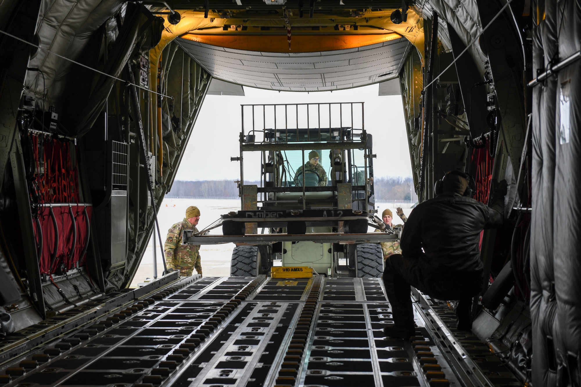 Airmen from the 76th Aerial Port Squadron load an airdrop training pallet onto a C-130J-30 Super Hercules aircraft at Youngstown Air Reserve Station, Ohio, Jan. 14, 2025.