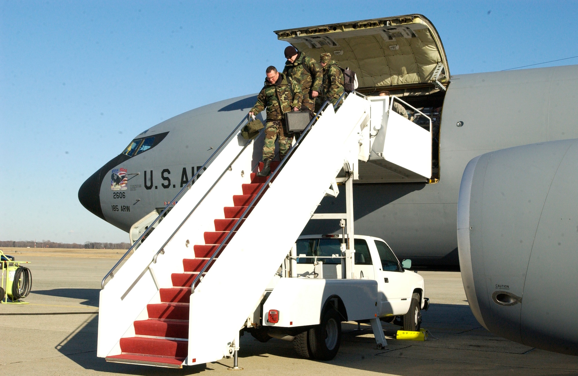 Airmen from the 132nd Fighter Wing, based in Des Moines, Iowa, and 185th Air Refueling Wing, based in Sioux City, Iowa, disembark from a KC-135 Stratotanker after arriving at Andrews Air Force Base, Maryland, Jan. 16, 2009, to support the 56th presidential inauguration. It was the first time in its 170-year history that the Iowa National Guard participated in a presidential inauguration. (Photo by Army Spc. Cassandra Moore)
