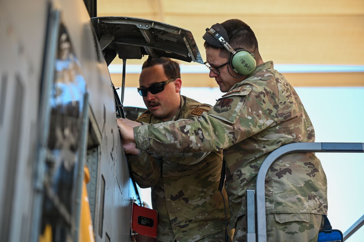 U.S. Air Force Senior Airman Ryan Holland, 355th Equipment Maintenance Squadron aircraft metals technician, left, and Senior Airman Austin Perez, 357th Fighter Generation Squadron avionics technician, right, drill new safety wire holes in an A-10C Thunderbolt II aircraft at Davis-Monthan Air Force Base, Arizona, Jan. 16, 2025. Proper aircraft maintenance is crucial as it ensures the safety of the aircraft in flight. (U.S. Air Force photo by Airman Samantha Melecio)