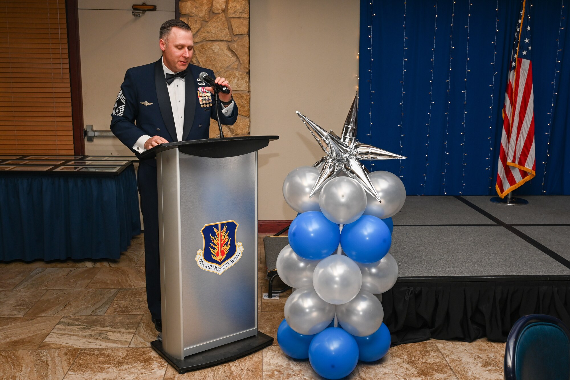 U.S. Air Force Chief Master Sgt. Andrew Shone, 97th Missions Support Group senior enlisted leader, delivers a speech during the noncommissioned officer (NCO) induction ceremony in Club Altus at Altus Air Force Base, Oklahoma, Jan. 16, 2025. Shone spoke on the importance of NCOs and their leadership skills in the Air Force. (U.S. Air Force Photo by Airman 1st Class Jonah Bliss)