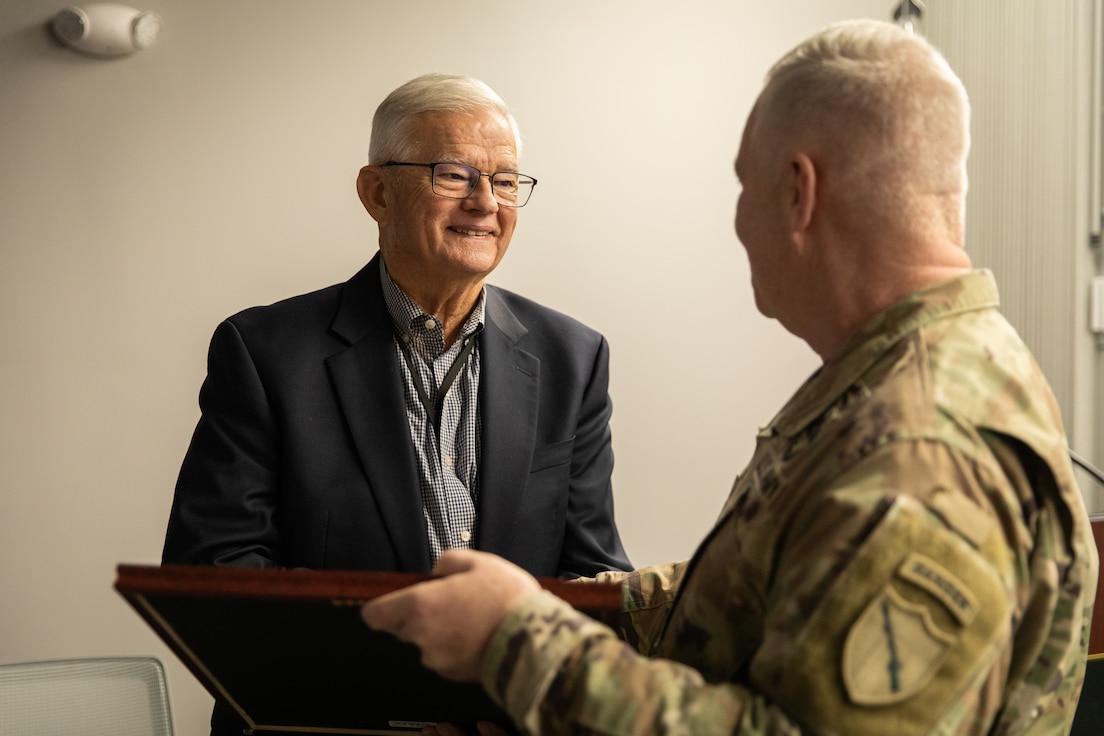 Retired U.S. Army Maj. Gen. Stephen Collins, left, is presented with the Superior Civilian Service Medal by Maj. Gen. Haldane Lamberton, Kentucky adjutant general, at his retirement ceremony at Bluegrass Station in Lexington, Kentucky on Dec. 10, 2025.