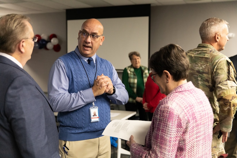 Retired U.S. Army Col. J.B. Richmond talks with guests of retired Maj. Gen. Stephen Collins' retirement ceremony at Bluegrass Station in Lexington, Kentucky on Dec. 10, 2025.