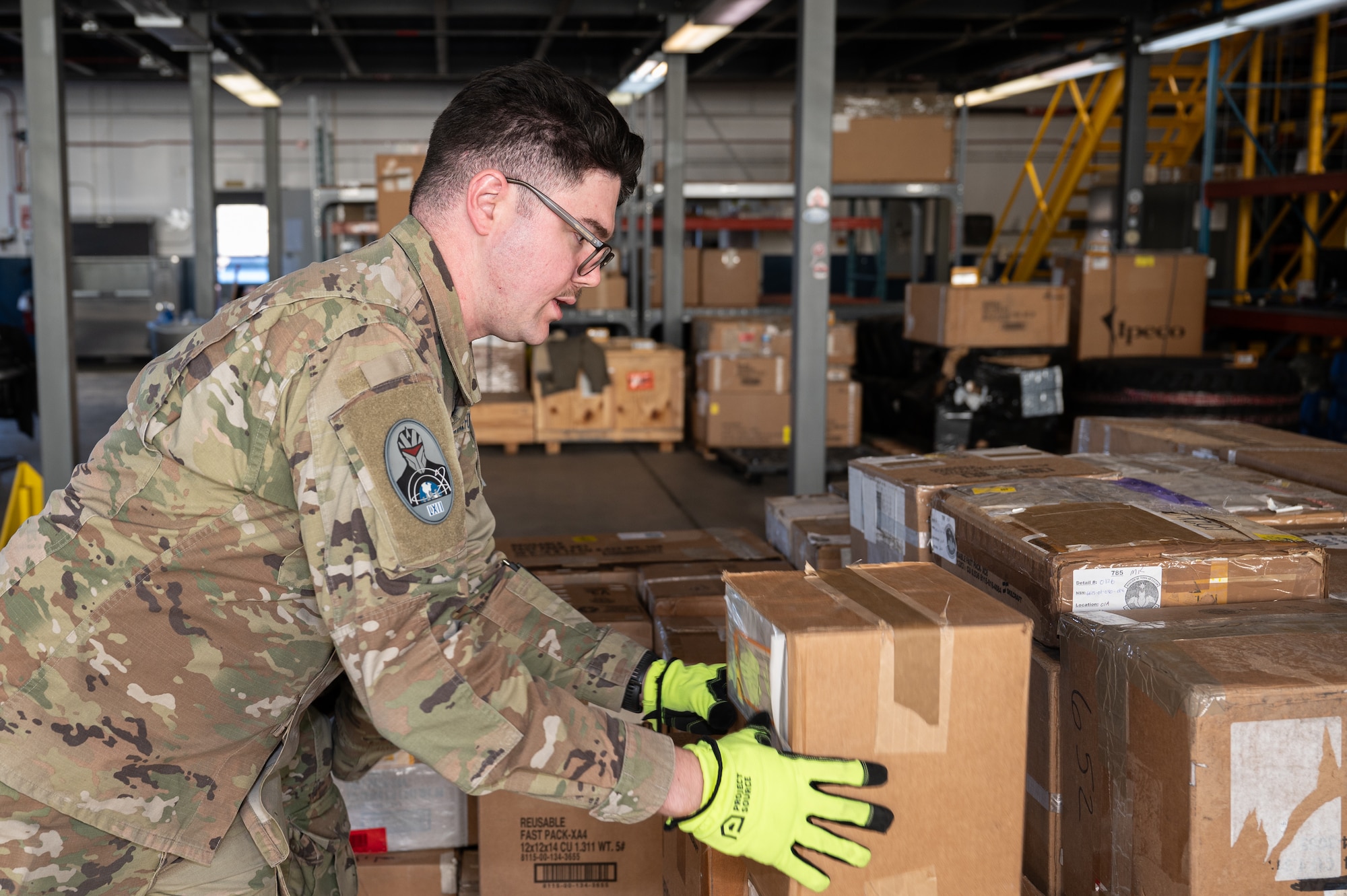 U.S. Space Force Spc. 4 Blake Settoon, 62nd Cyberspace Squadron defensive cyber operator, places a box during a logistics readiness squadron challenge at Peterson Space Force Base, Colorado, Jan. 15, 2025. Participants included Airmen and Guardians from different career fields, some of whom had never been a part of a supply logistics process, and identified how they interacted with loading cargo in the context of a space logistics concept. (U.S. Space Force photo by 2nd Lt Jacob Willoughby)