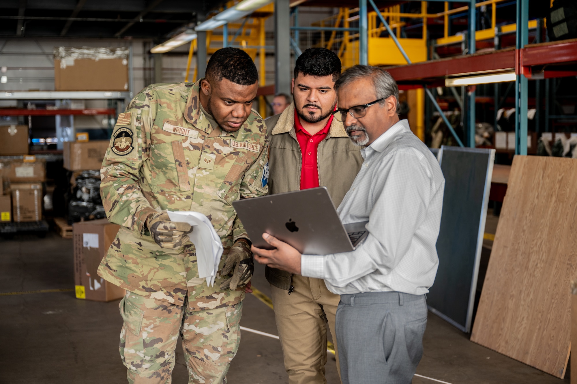 U.S. Air Force Senior Airman Ricardo Wright, 21st Logistics Readiness Squadron central storage journeyman, Derrick Morales, Space Force PALACE Acquire civilian, and name, locate where artificial intelligence has decided the next box of cargo should go during an LRS exercise at Peterson Space Force Base, Colorado, Jan. 15, 2025. One of the key takeaways from the challenge was the potential for real-time human-AI collaboration. (U.S. Space Force Photo by 2nd Lt. Jacob Willoughby)