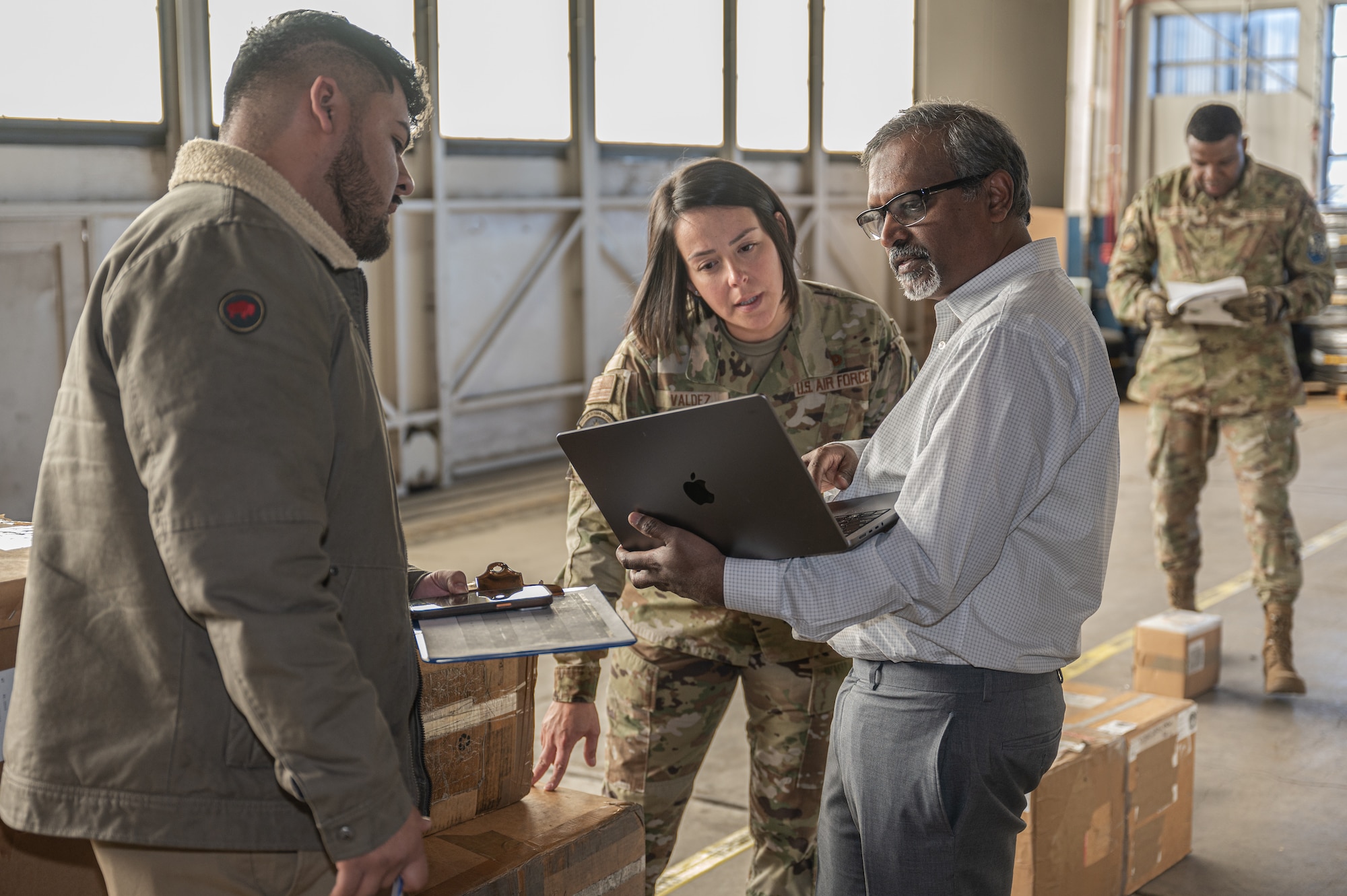 U.S. Air Force Master Sgt. Audrey Valdez, 21st Logistics Readiness Squadron materiel management superintendent, Derrick Morales, Space Force PALACE Acquire civilian, and Pradeep Mangalagiri, an artificial intelligence scientist, discuss the AI model used in a day-long logistics challenge at Peterson Space Force Base, Colorado, Jan. 15, 2025. The challenge, led by Space System Command's Directorate of Installation, Logistics, and Product Support (S4), brought together logisticians, engineers, and leaders to tackle a complex problem: how to optimally fit 111 boxes of cargo into a standard military container. (U.S. Space Force Photo by 2nd Lt. Jacob Willoughby