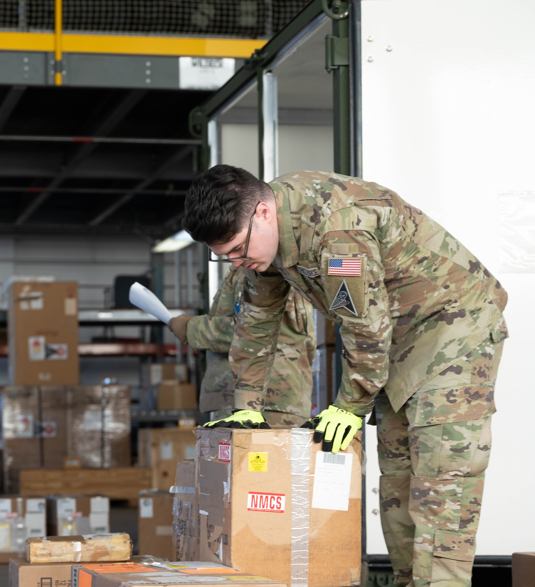 U.S. Space Force Spc. 4 Blake Settoon, 62nd Cyberspace Squadron defensive cyber operator, reviews the labeling on a box during the space logistics challenge at Peterson Space Force Base, Colorado, Jan. 15, 2025. This day-long challenge was the first time an artificial intelligence tool was used in loading a military container, paving the way for more rapid planning and loading in future. (U.S. Space Force photo by Staff Sgt. Jaime Sanchez)