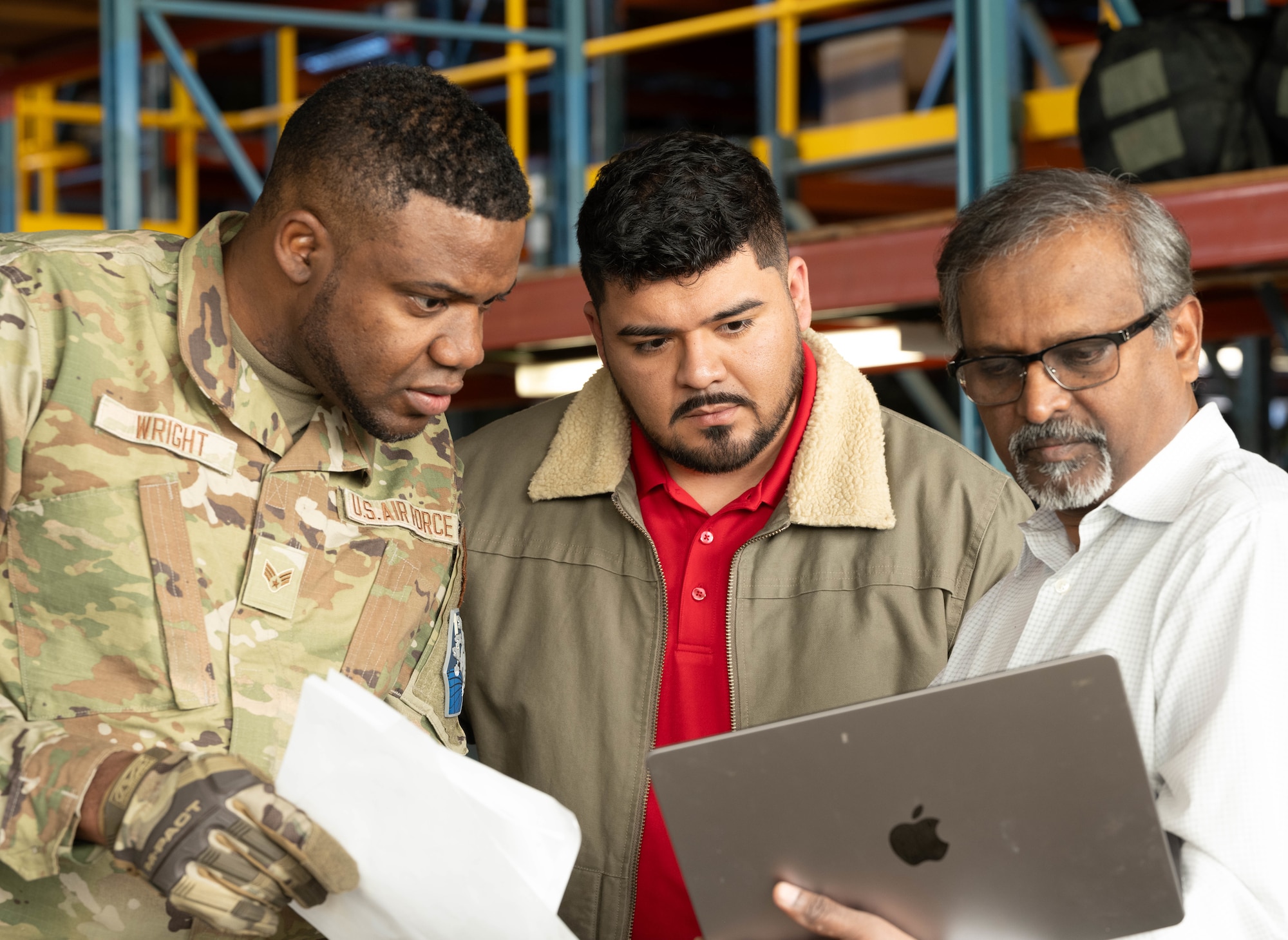 From left, U.S. Air Force Senior Airman Ricardo Wright, 21st Logistics Readiness Squadron central storage journeyman, Derrick Morales, Space Force PALACE Acquire civilian, and Pradeep Mangalagiri, an artificial intelligence scientist, look over optimized instructions provided by the artificial intelligence tool during the space logistics challenge at Peterson Space Force Base, Colorado, Jan. 15, 2025. The challenge allowed members to utilize artificial intelligence tools to optimize the loading of cargo into a military container. (U.S. Space Force photo by Staff Sgt. Jaime Sanchez)