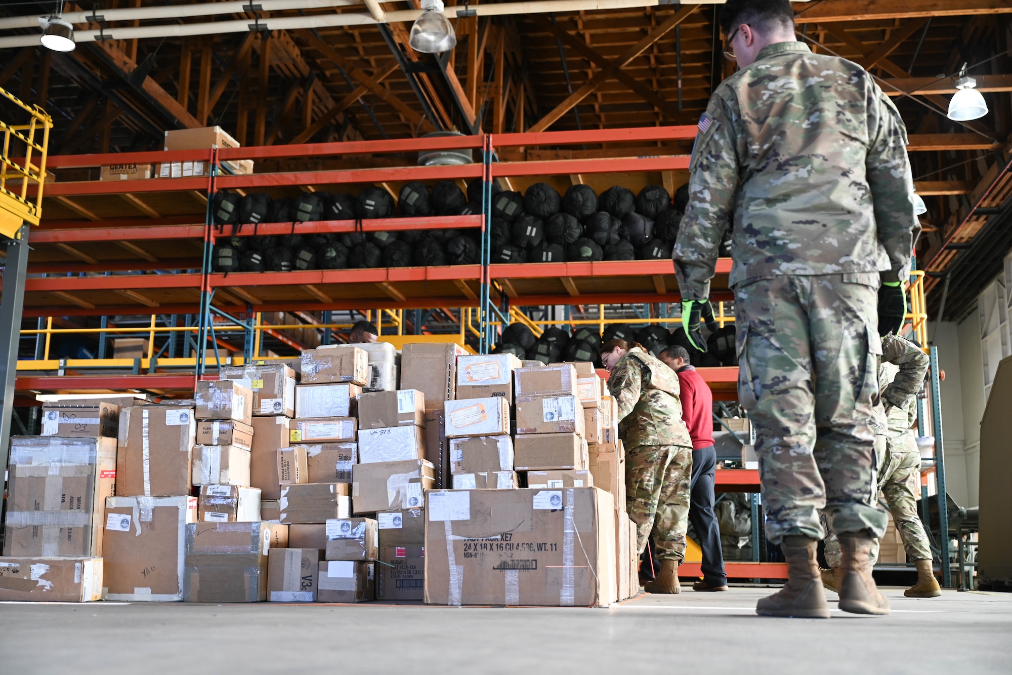 Participants stack 111 boxed during the space logistics challenge at Peterson Space Force Base, Colorado, Jan. 15, 2025. The challenge allowed members to utilize artificial intelligence tools to optimize the loading of cargo into a military container. (U.S. Space Force photo by Staff Sgt. Jaime Sanchez)