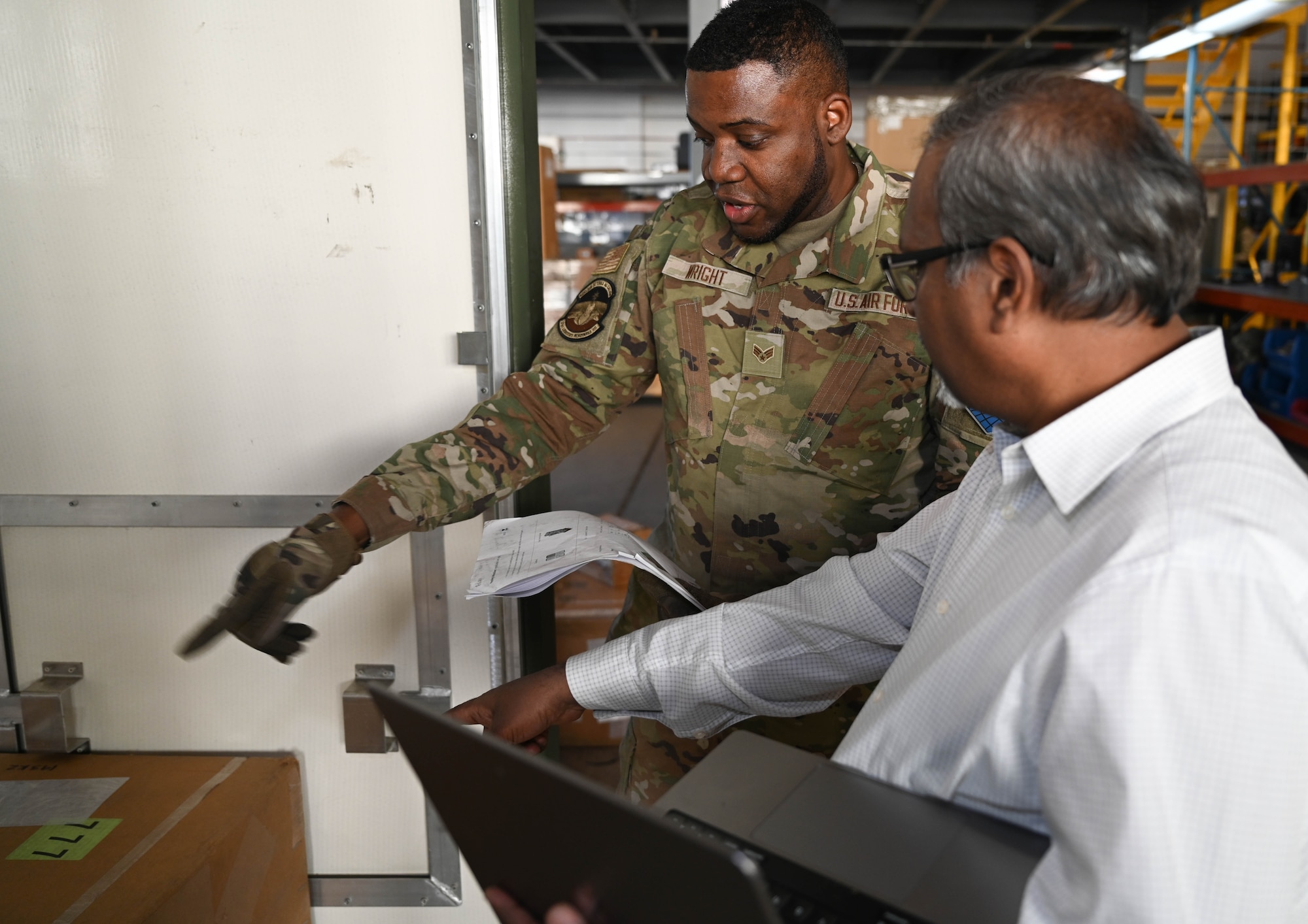U.S. Air Force Senior Airman Ricardo Wright, 21st Logistics Readiness Squadron central storage journeyman and Pradeep Mangalagiri, an artificial intelligence scientist, discuss the optimized instructions provided by the artificial intelligence tool during the space logistics challenge at Peterson Space Force Base, Colorado, Jan. 15, 2025. The final test showcased the ability for the AI tool to develop loading instruction for personnel, enabling human-AI collaboration. (U.S. Space Force photo by Staff Sgt. Jaime Sanchez)