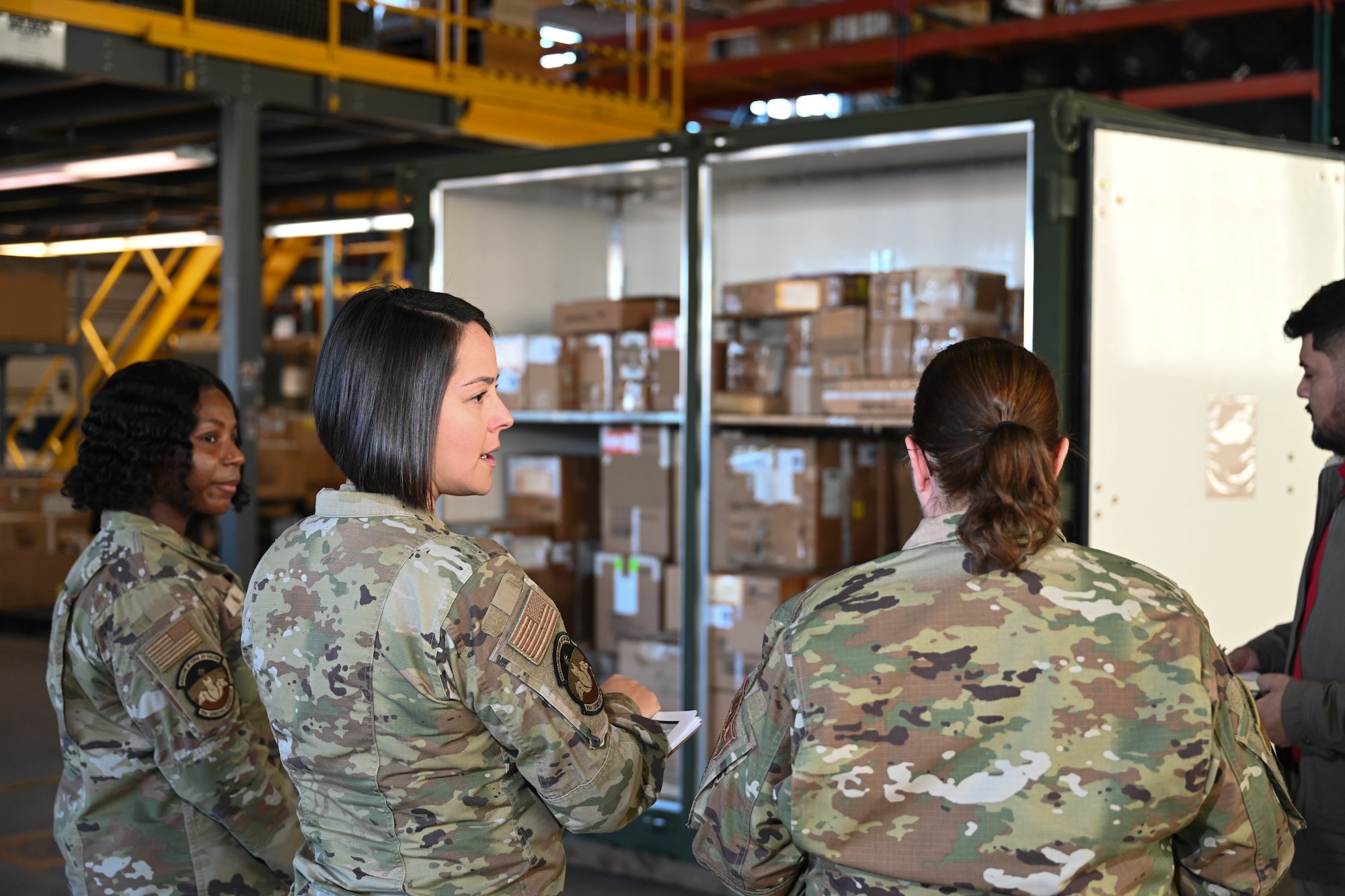 From left, U.S. Air Force Airman 1st Class Mya Nare, 21st Logistics Readiness Squadron air transportation journeyman, USAF Master Sgt. Audrey Valdez, 21 LRS chief of asset management, and USAF Staff Sgt. Marnie Brannen, 302nd LRS materiel management craftsman, debrief after the second round of tests during the space logistics challenge at Peterson Space Force Base, Colorado, Jan. 15, 2025. Three teams were used to set a baseline to compare the effectiveness of loading cargo, using artificial intelligence’s optimized instructions. (U.S. Space Force photo by Staff Sgt. Jaime Sanchez)