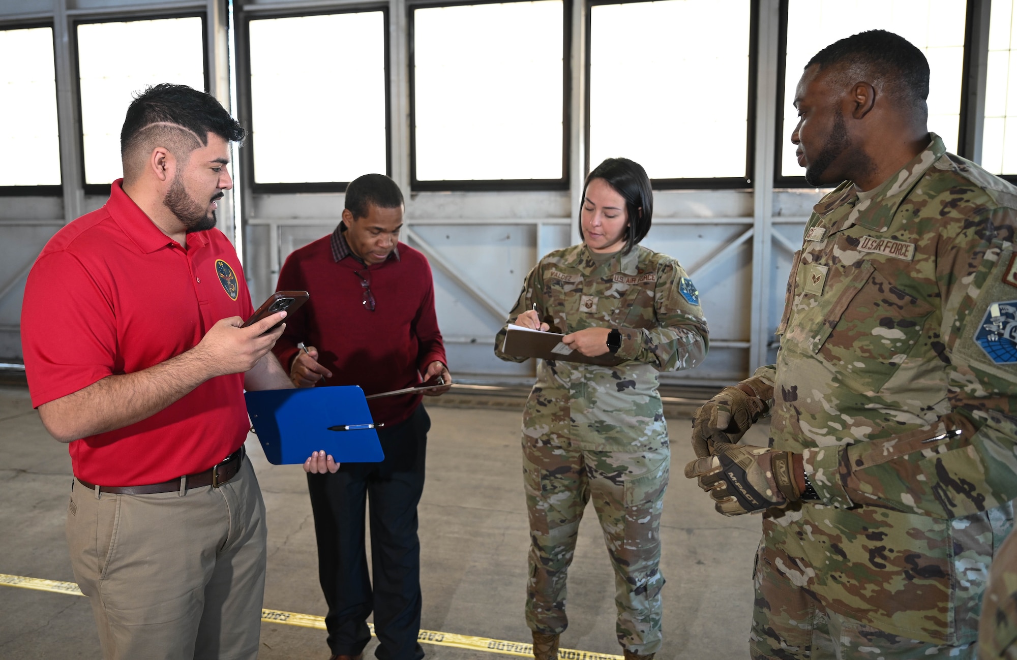 From left, Derrick Morales, Space Force PALACE Acquire civilian, Kory Gibson, 21st Logistics Readiness Squadron chief of asset management, U.S. Air Force Master Sgt. Audrey Valdez, 21st LRS materiel management superintendent, U.S. Air Force Senior Airman Ricardo Wright, 21st LRS central storage journeyman, discuss objectives at the start of the first test at Peterson Space Force Base, Colorado, Jan. 15, 2025. The space logistics challenge brought together members of different skill levels as a comparison to see the efficiency of the artificial intelligence being tested in the event. (U.S. Space Force photo by Staff Sgt. Jaime Sanchez)