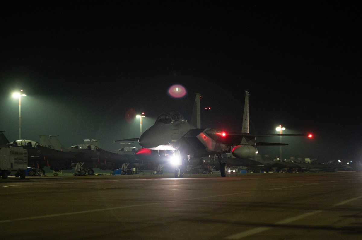 An aircraft taxis down a ramp.