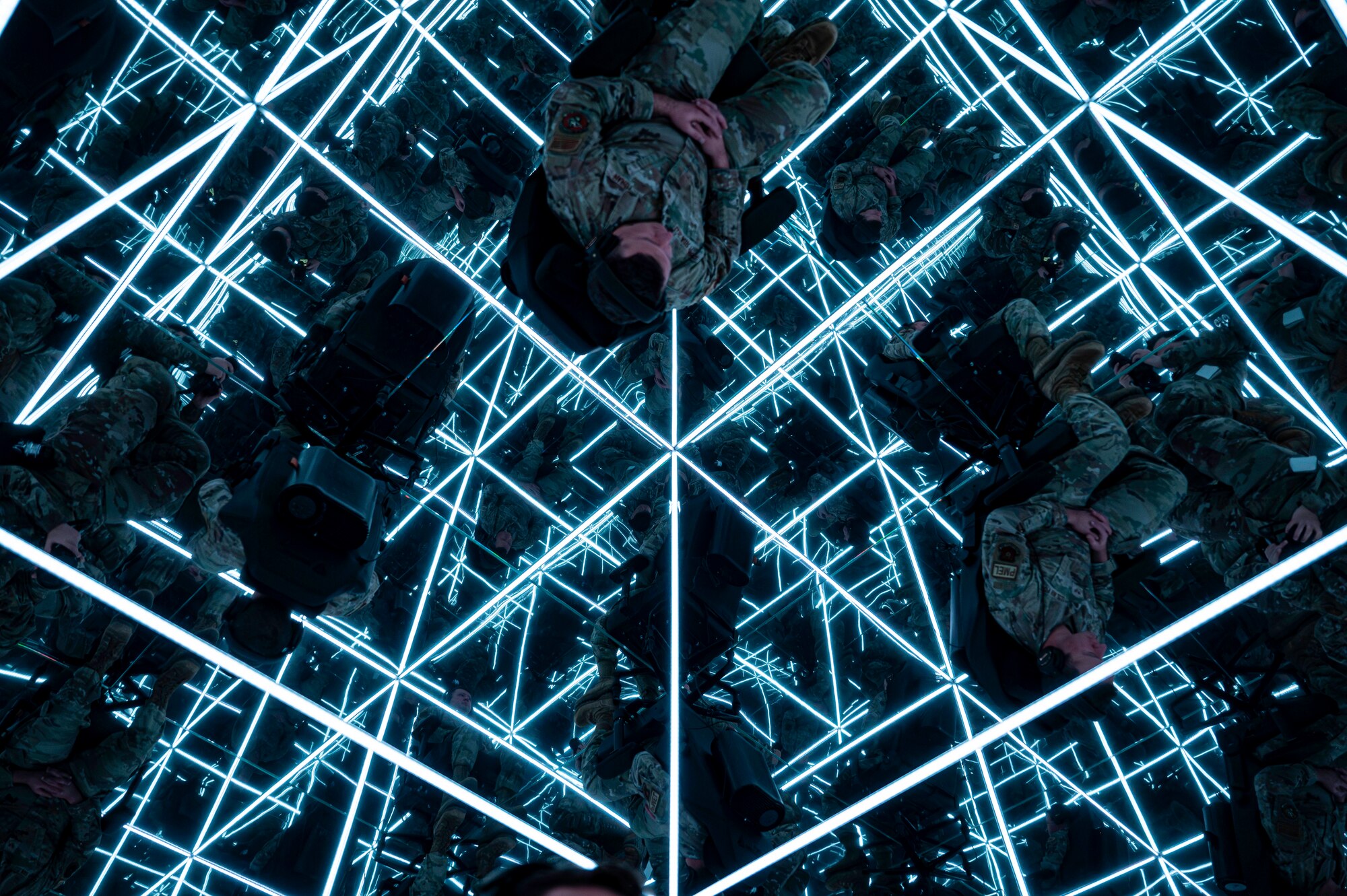 military man sits in the mind gym, surrounded my mirrors and LED lights