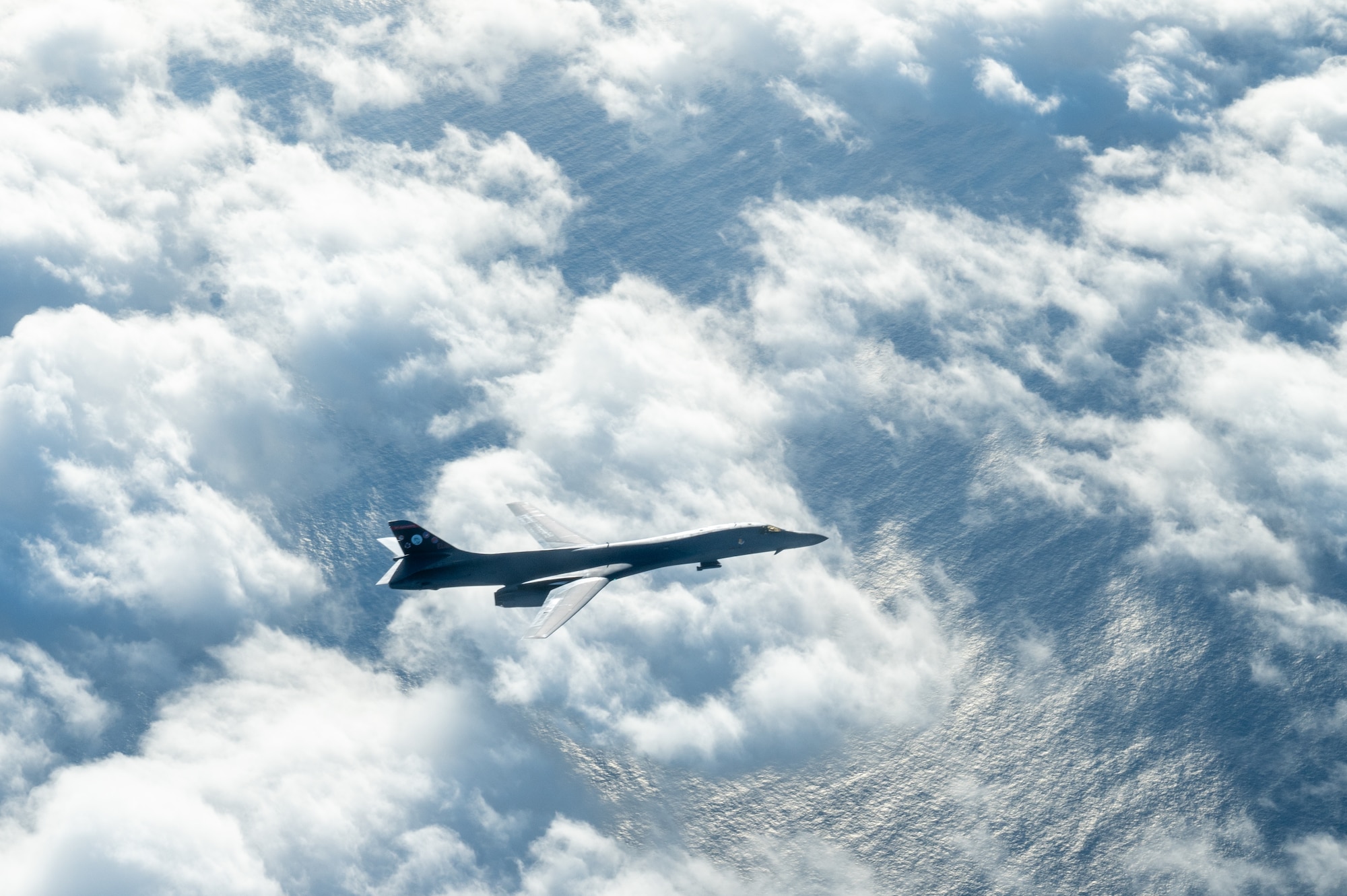 A bomber descends after conducting aerial refueling.