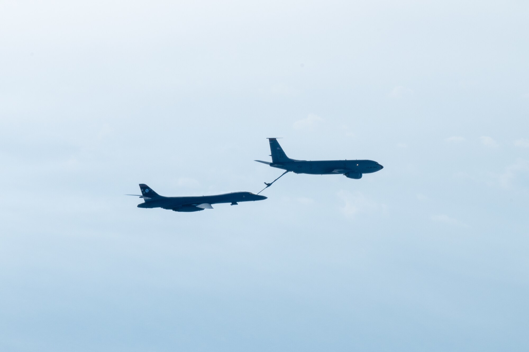 A bomber conducts aerial refueling with a tanker aircraft.