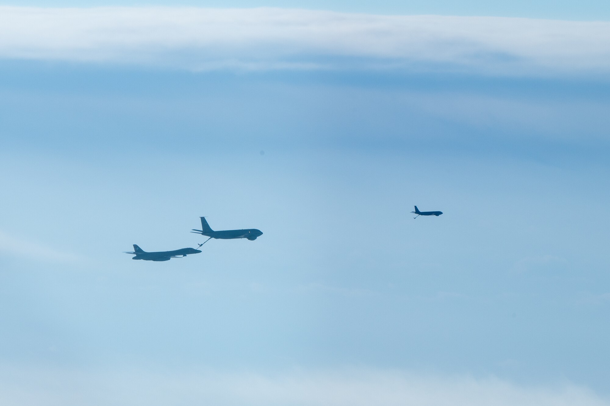 A bomber conducts aerial refueling with a tanker aircraft.