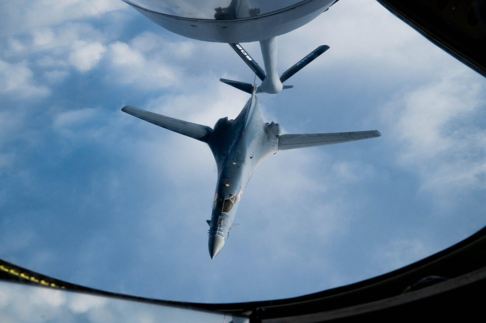 A bomber disconnects from a boom after aerial refueling.