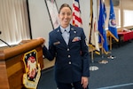 a woman in uniform stands at a podium