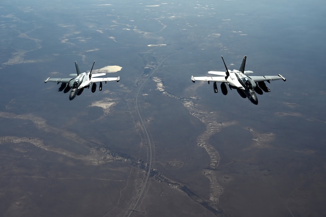 Two U.S. Navy EA-18G Growlers fly in formation during an Operation Inherent Resolve mission over the U.S. Central Command area of responsibility.