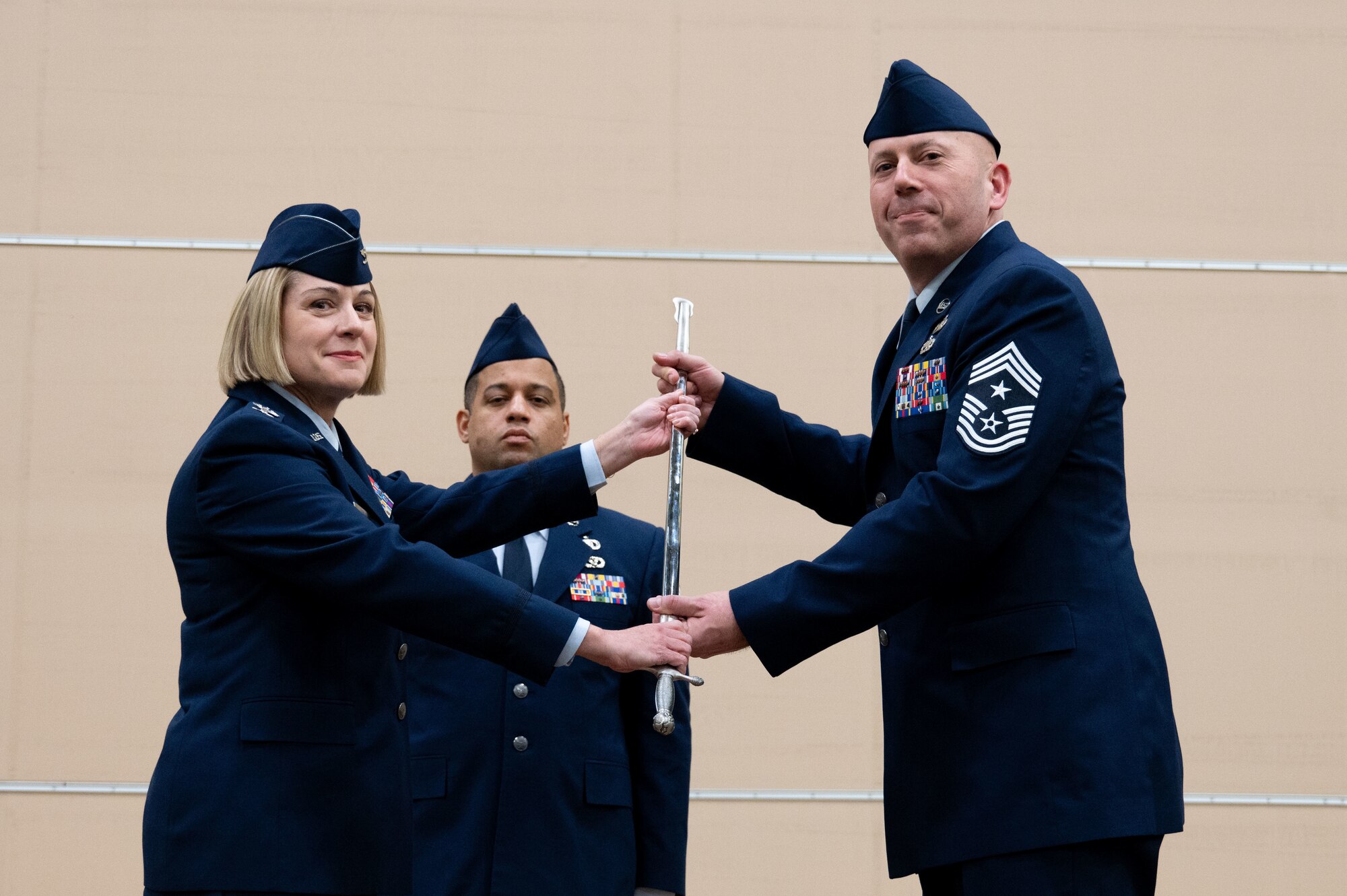 Airmen pass a sword.