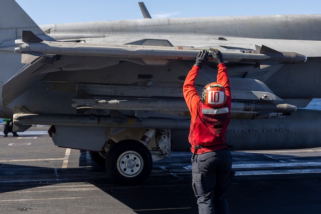 A U.S. Navy Sailor checks ordnance on an F/A-18E Super Hornet before it launches from the Nimitz-class aircraft carrier USS Harry S. Truman (CVN 75) in the U.S. Central Command area of responsibility.