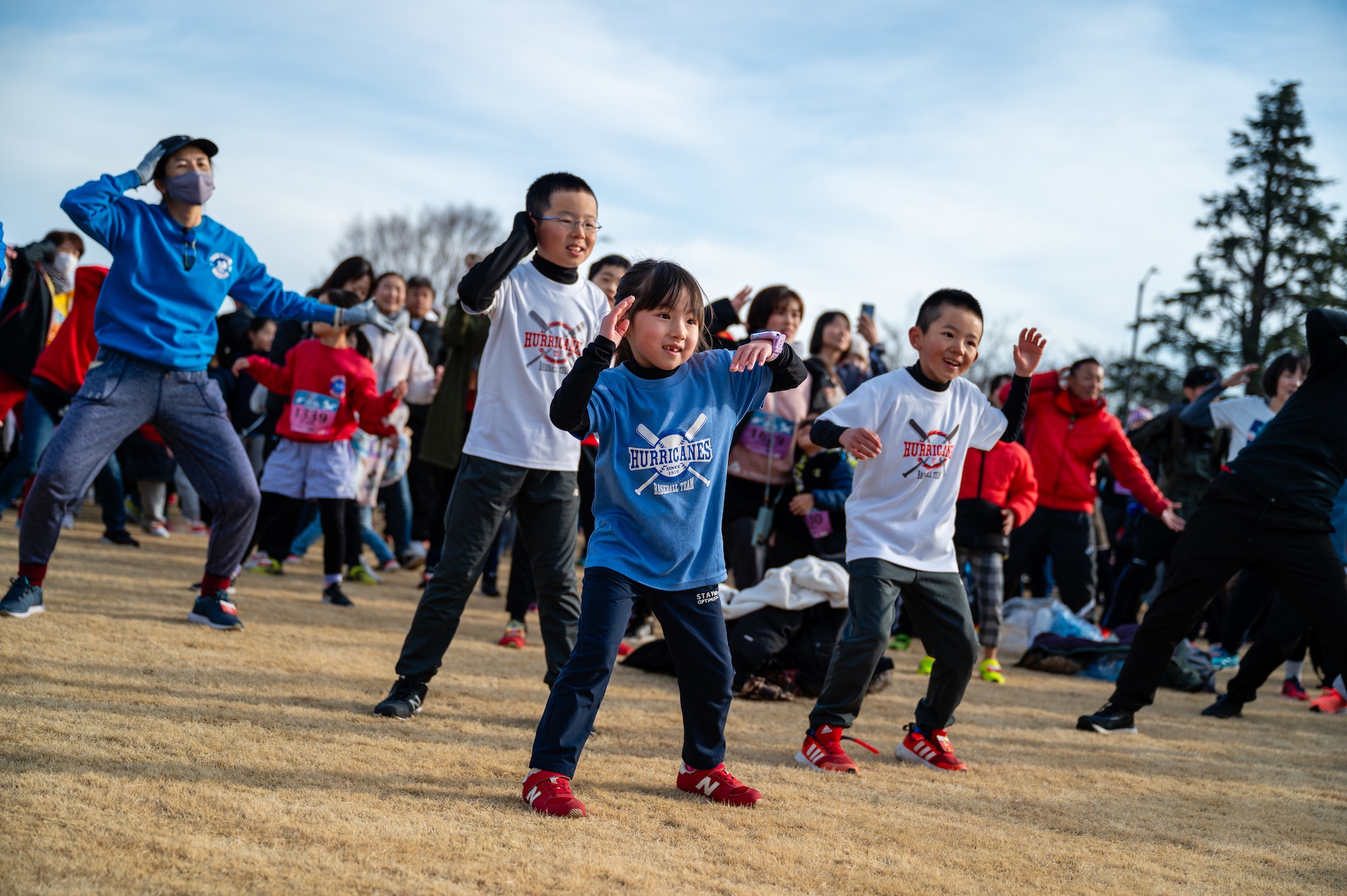 Children participate in a Zumba warm-up to prepare for the 44th Annual Frostbite Road Race at Yokota Air Base, Japan.