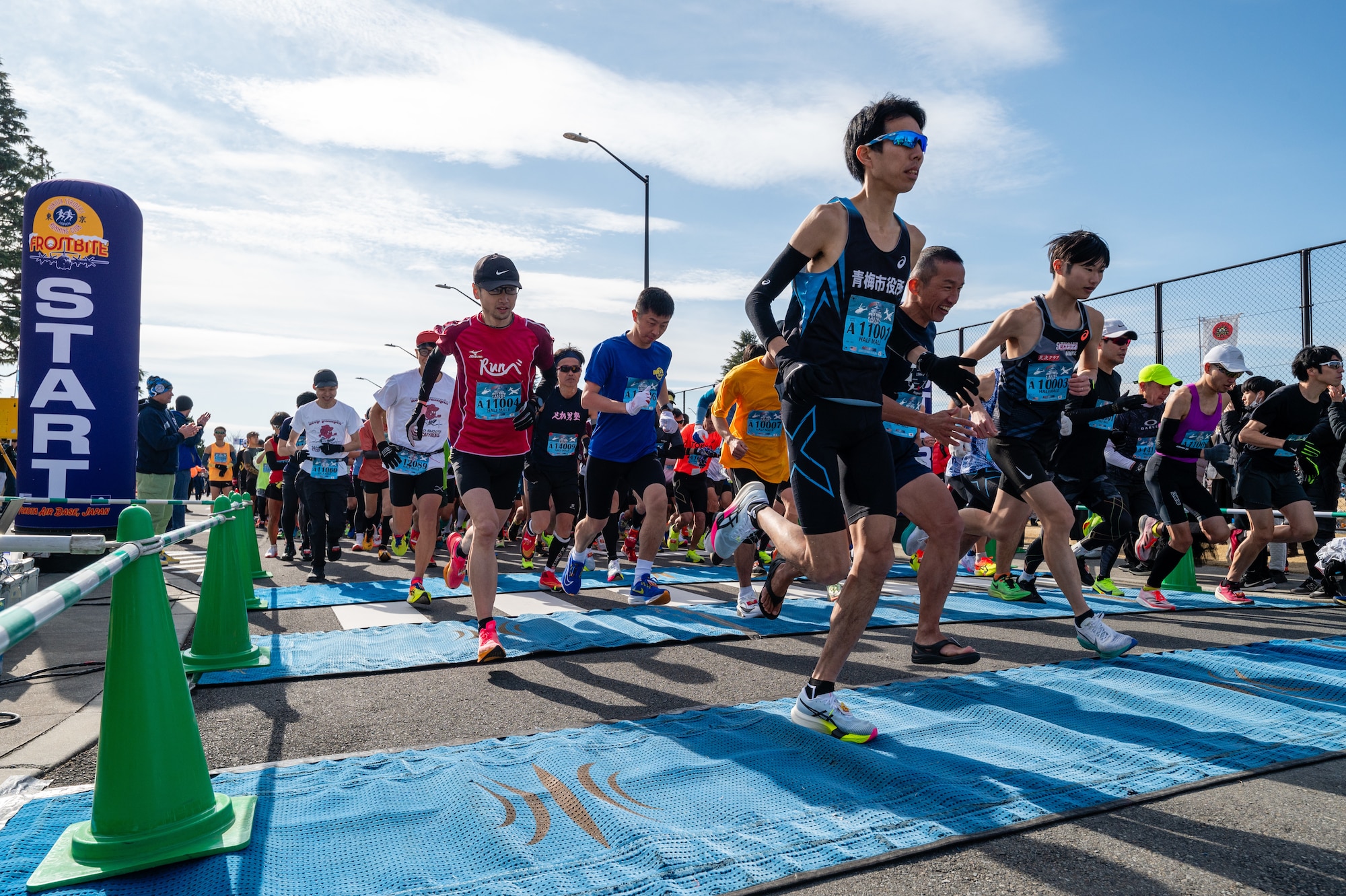 Half-marathon runners launch from the starting line during the 44th Annual Frostbite Road Race at Yokota Air Base, Japan.