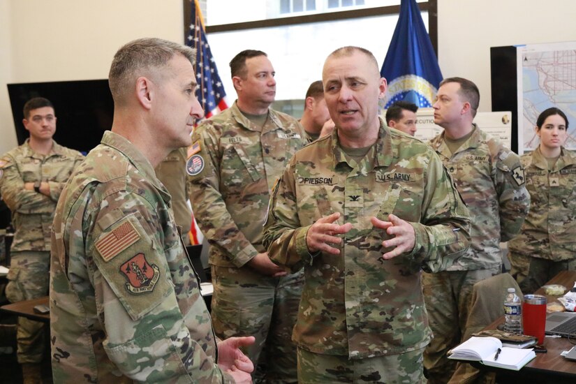 U.S. Air Force Gen. Steven Nordhaus, left, Chief of the National Guard Bureau, speaks with U.S. Army Col. Brad Pierson, commander of the 55th Maneuver Enhancement Brigade, Pennsylvania Army National Guard, to discuss current operations of service members assigned to Joint Task Force-District of Columbia (JTF-DC), in Washington, D.C., Jan. 19, 2025. Approximately 8,000 National Guard service members from approximately 40 states and territories comprise JTF-DC to support the 60th Presidential Inauguration, continuing a legacy that began in 1789 when their predecessors escorted George Washington to the first inauguration. At the request of civil authorities, these National Guard service members provide critical support such as crowd management, traffic control points, CBRN response, civil disturbance response and sustainment operations. Their expertise and seamless collaboration with interagency partners help ensure a safe and peaceful transition of power during this historic event. (U.S. Army National Guard photo by Sgt. 1st Class Shane Smith)