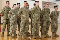 Soldiers stand in formation during a mobilization ceremony for the 634th Brigade Support Battalion Forward Logistics Element Jan. 20, 2025, at the Illinois Army National Guard's Readiness Center in Sullivan. The unit, with just over a dozen Soldiers, will support logistics for U.S. Army Europe and Africa.